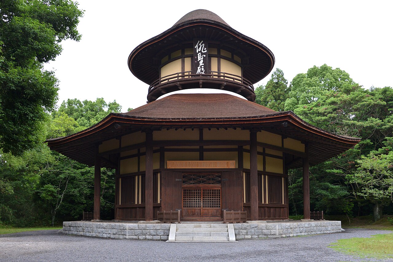 The Haiseiden in Ueno Park, an octagonal wooden hall with a two-tiered cypress-bark roof surrounded by green trees