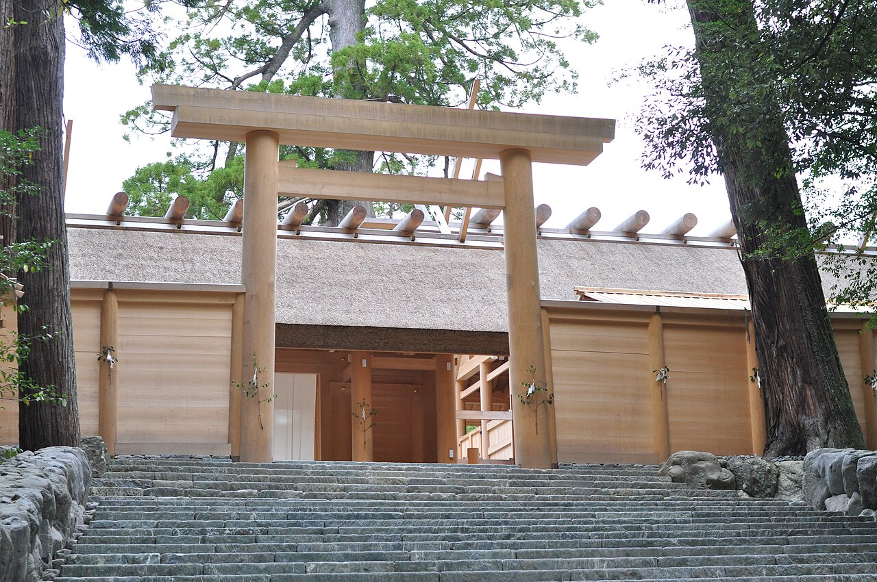 Broad stone steps rising toward a wooden torii and fenced sanctuary among trees at the Inner Shrine