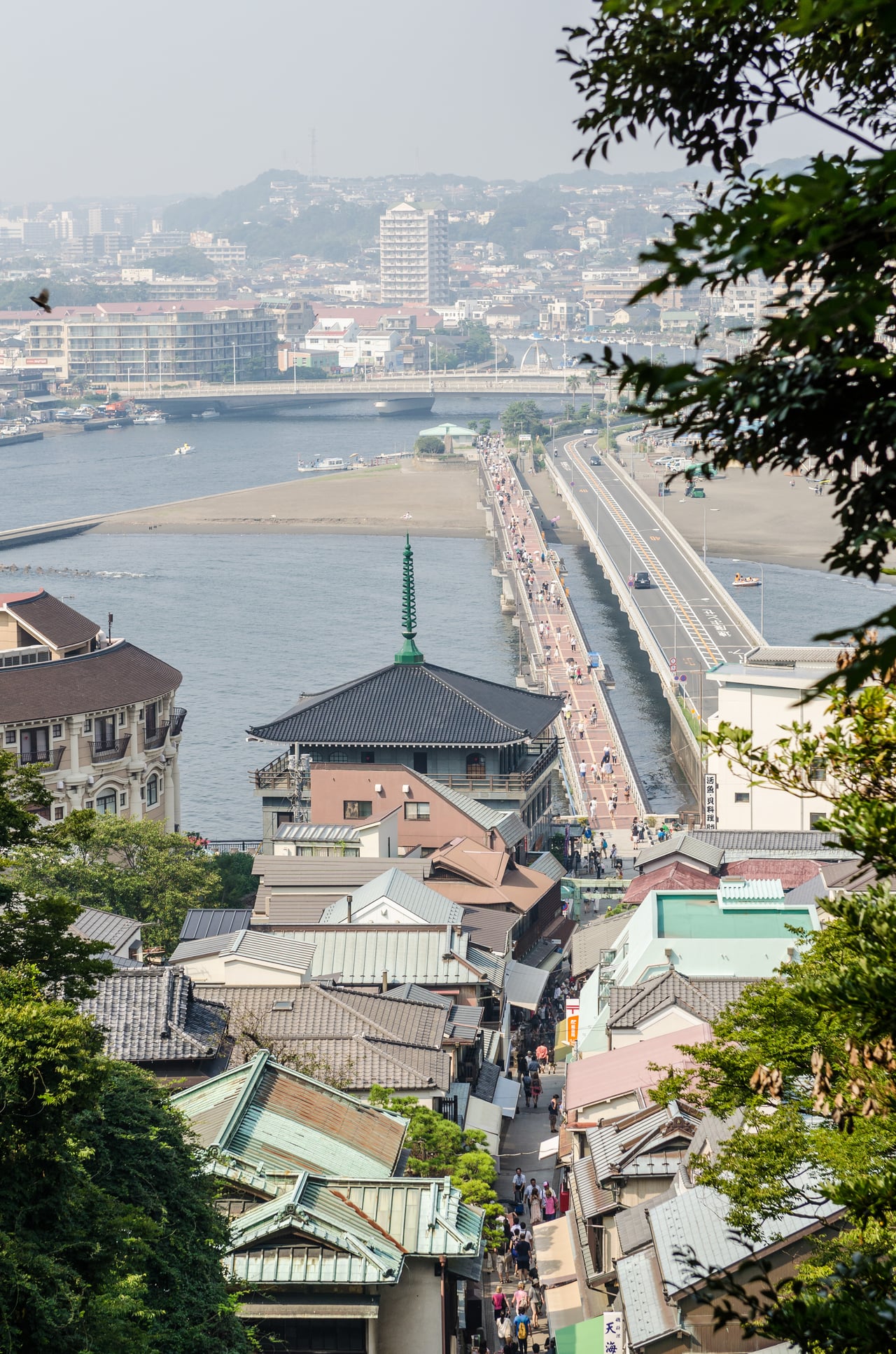 An aerial view of Enoshima Island's shops and buildings, with the bridges connecting it to the mainland near Fujisawa, Kanagawa.