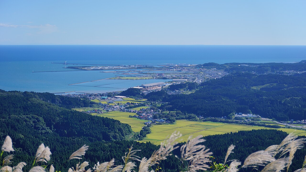 Looking down from Mount Kanpu over the port town of Oga with its harbor breakwaters, rice fields and the Sea of Japan beyond.