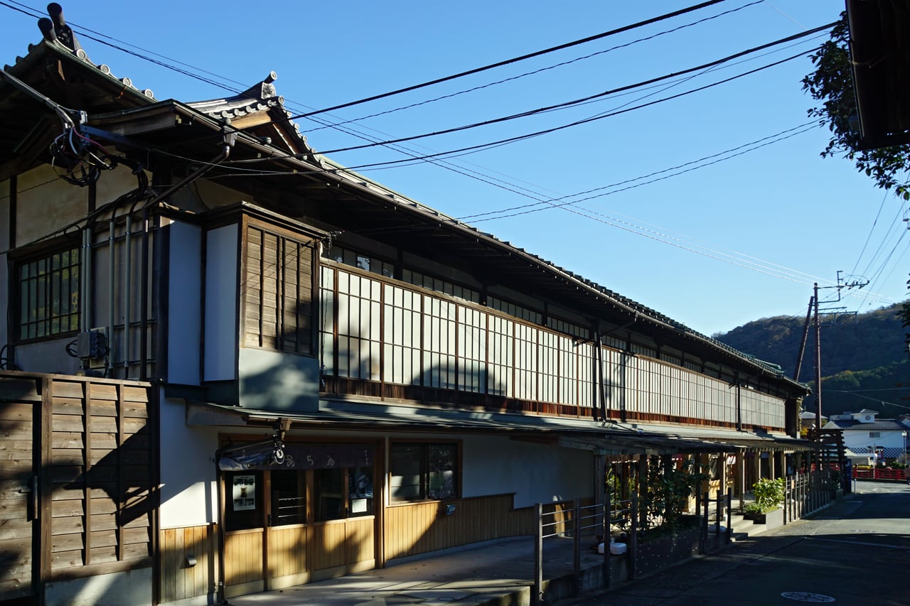 Traditional wooden ryokan and shop buildings line a street in the hot-spring town of Shuzenji, Izu, Shizuoka Prefecture.