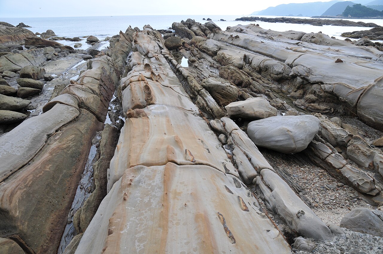 Long ridges of weathered sandstone running toward the sea along the Tatsukushi coast