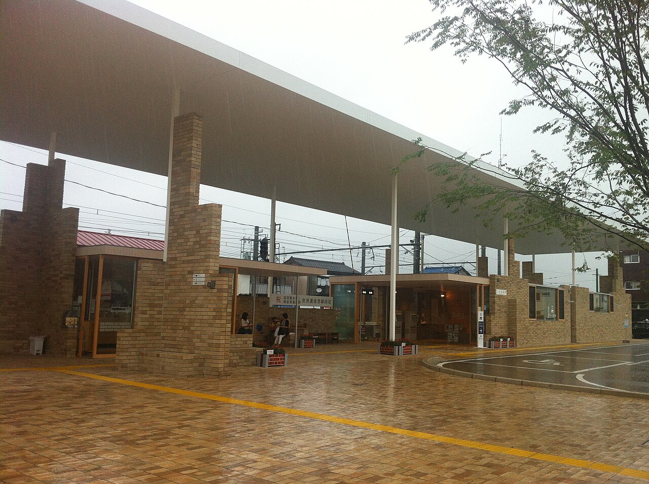 Joshu-Tomioka Station, a brick and glass building under a broad flat roof