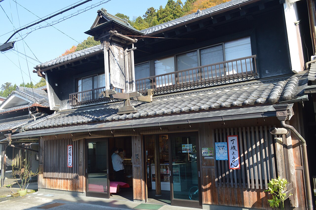 A tile-roofed merchant house with lattice windows and a small tower in Uda-Matsuyama