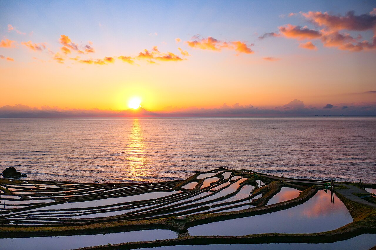 Sunset over the flooded terraces of Shiroyone Senmaida on the Sea of Japan coast